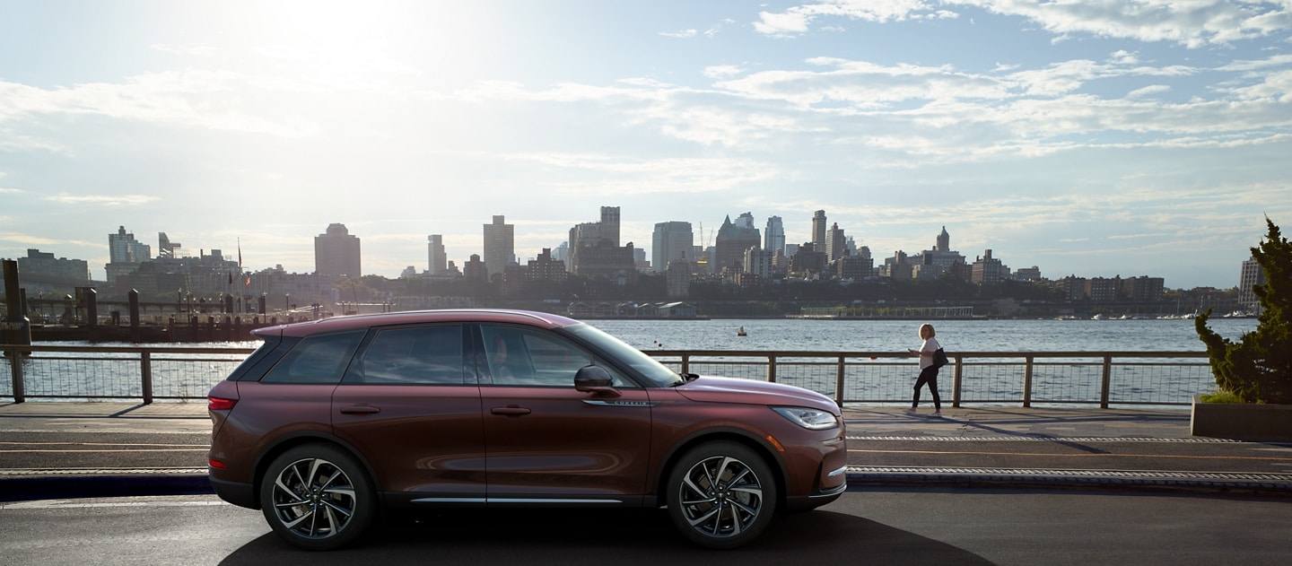 A U.S. preproduction model computer-generated image of a 2023 Lincoln Corsair SUV is shown parked by a river in a city