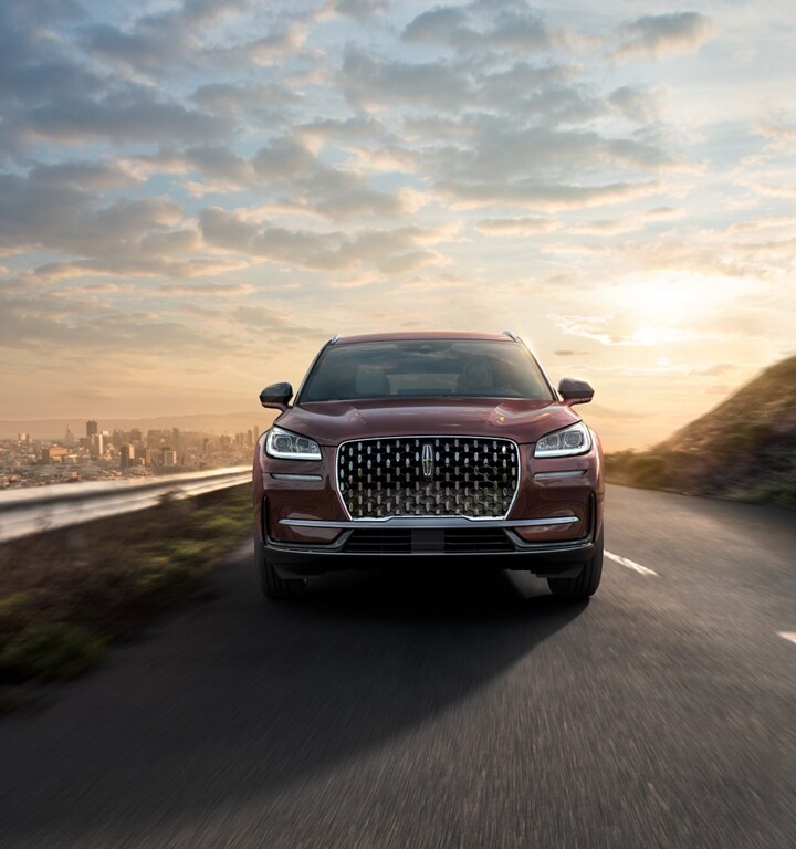 A 2023 Lincoln Corsair SUV is being driven on a hillside road