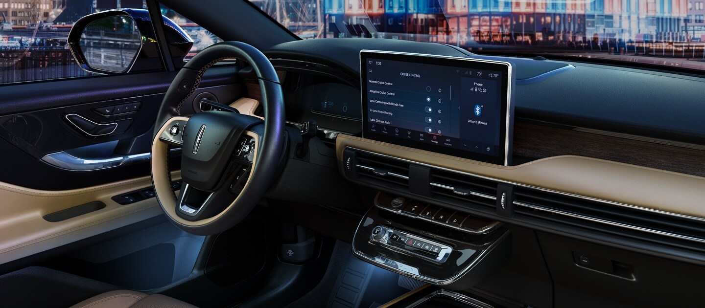 The floating centre console shows off sleek controls featuring black and bright chrome accents and storage space below