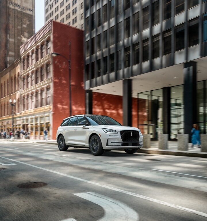 A 2023 Lincoln Corsair SUV with the Jet Appearance Package is being driven in the city
