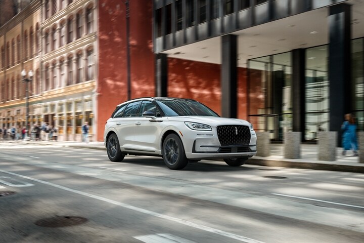 A 2023 Lincoln Corsair SUV with the available Jet Appearance Package is being driven in a city