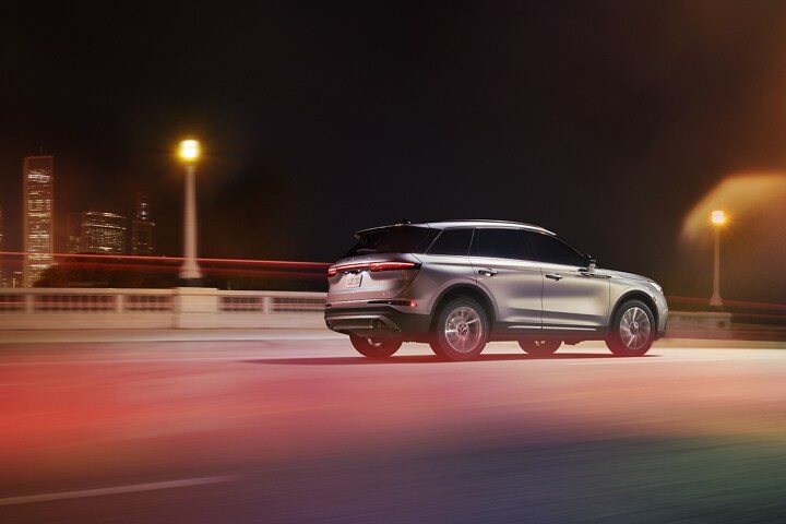 A 2023 Lincoln Corsair SUV is seen driving over a city bridge