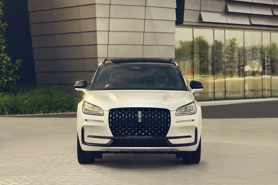 The dazzling LED headlamps of a 2024 Lincoln Corsair SUV sparkle in the sunlight