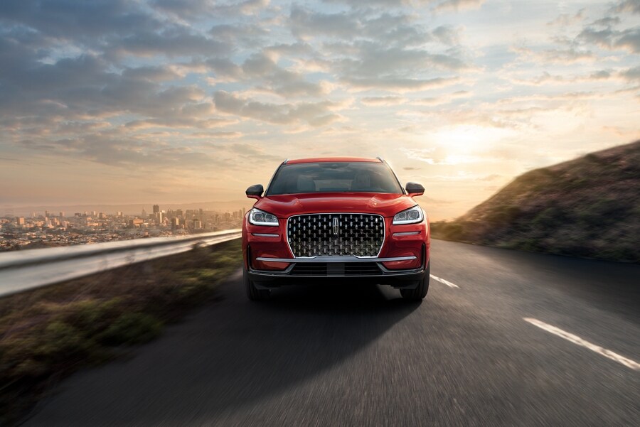 A 2024 Lincoln Corsair SUV is shown being driven on a hillside road