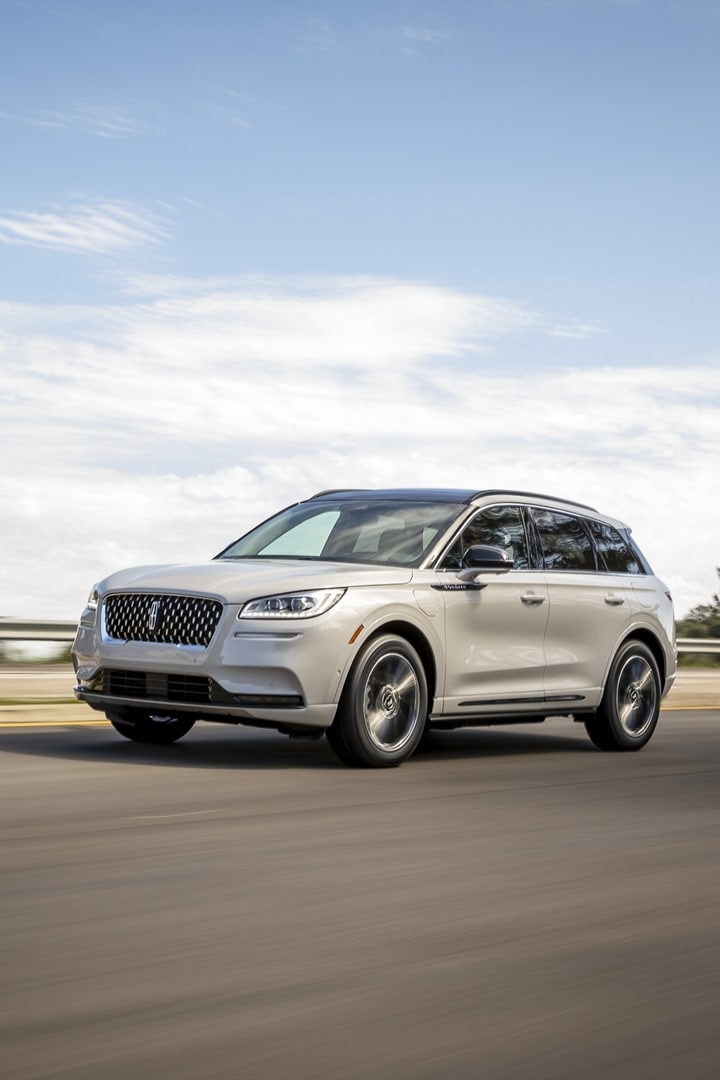 A 2026 Lincoln Corsair Grand Touring Plug-In Hybrid is being driven on a mountain road