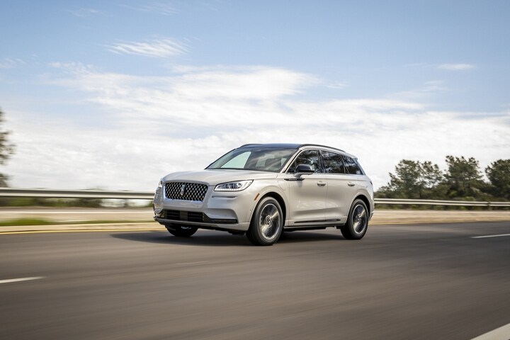 A 2025 Lincoln Corsair Grand Touring Plug-in Hybrid is being driven in the countryside