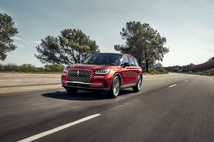 A 2025 Lincoln Corsair is being driven on a country road