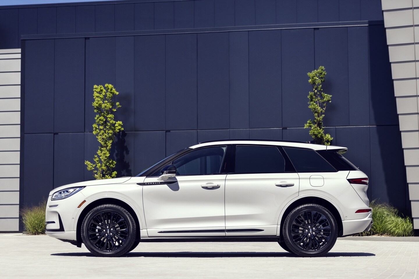 A 2025 Lincoln Corsair SUV with the available Jet Appearance Package is parked in front of a building