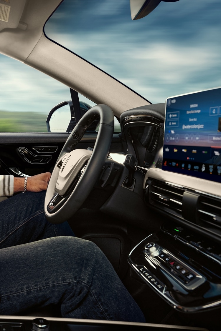 A driver enjoys using Lincoln BlueCruise hands-free restricted access divided highway driving