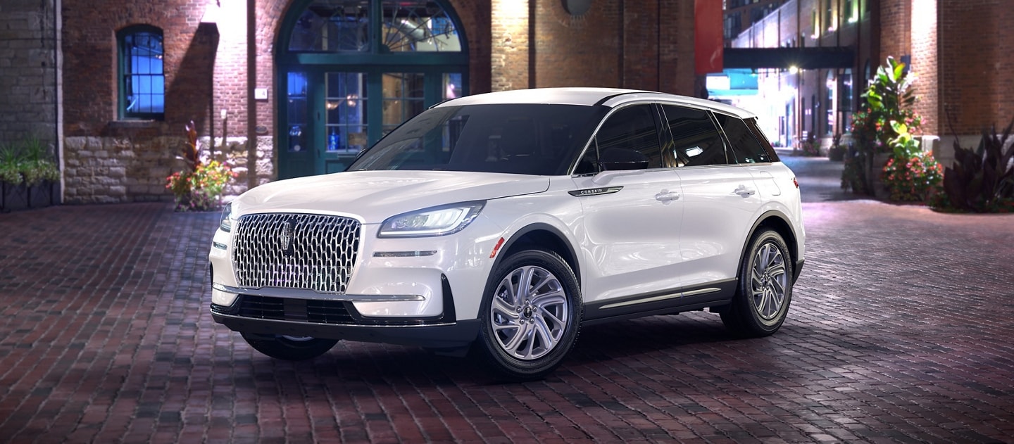 A 2025 Lincoln Corsair Premiere model is parked in a city at night