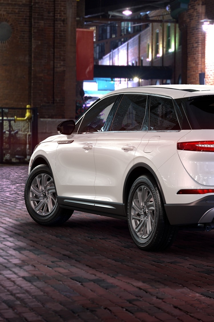 The rear of a 2025 Lincoln Corsair Premiere model is shown with a trailer hitch attached