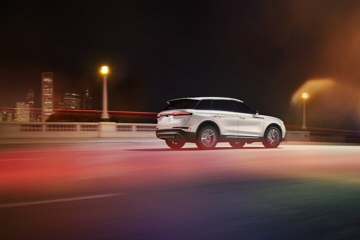 A 2025 Lincoln Corsair is being driven on a highway at night