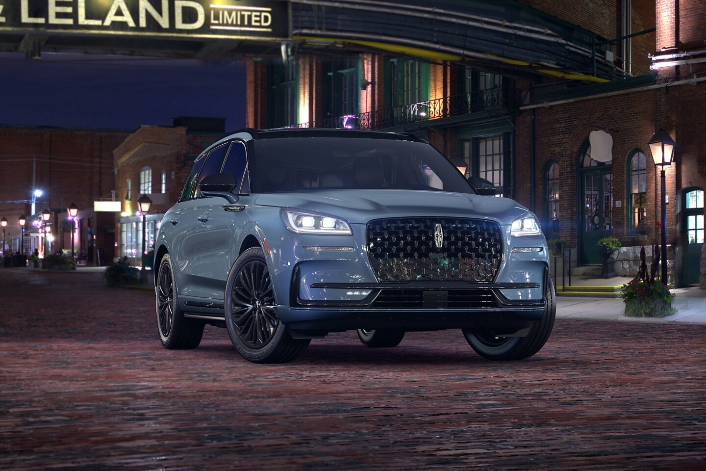 A 2026 Lincoln Corsair Grand Touring plug-in hybrid with the available Jet Appearance Package is parked in a city at night