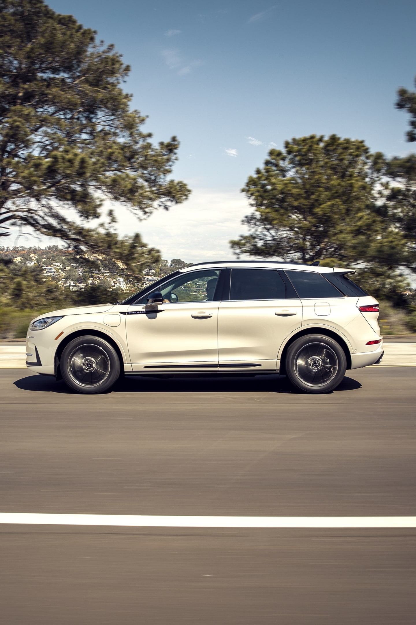 A 2026 Lincoln Corsair Grand Touring plug-in hybrid is being driven in the countryside