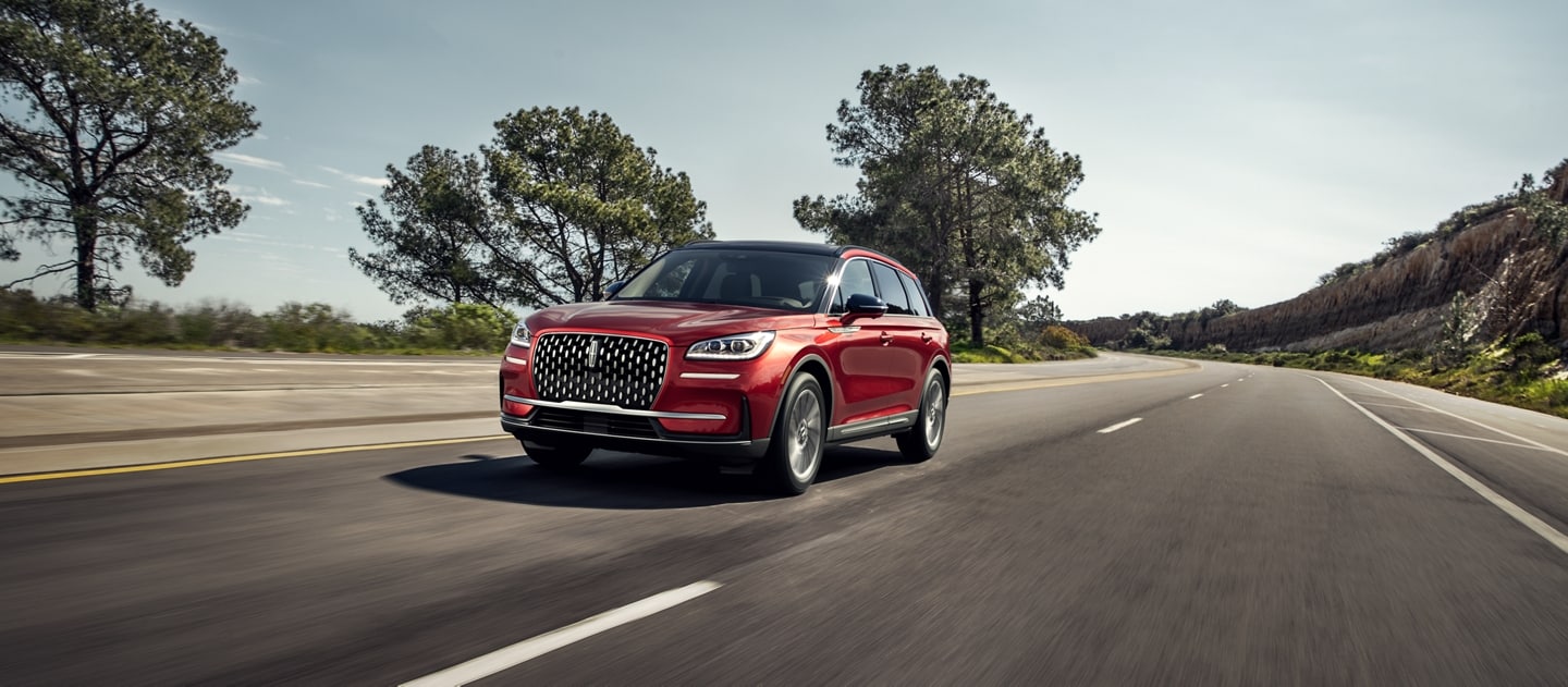 A 2026 Lincoln Corsair SUV is being driven on a country road