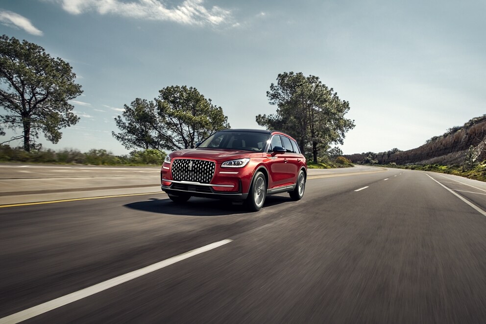 A 2026 Lincoln Corsair SUV is being driven on a country road