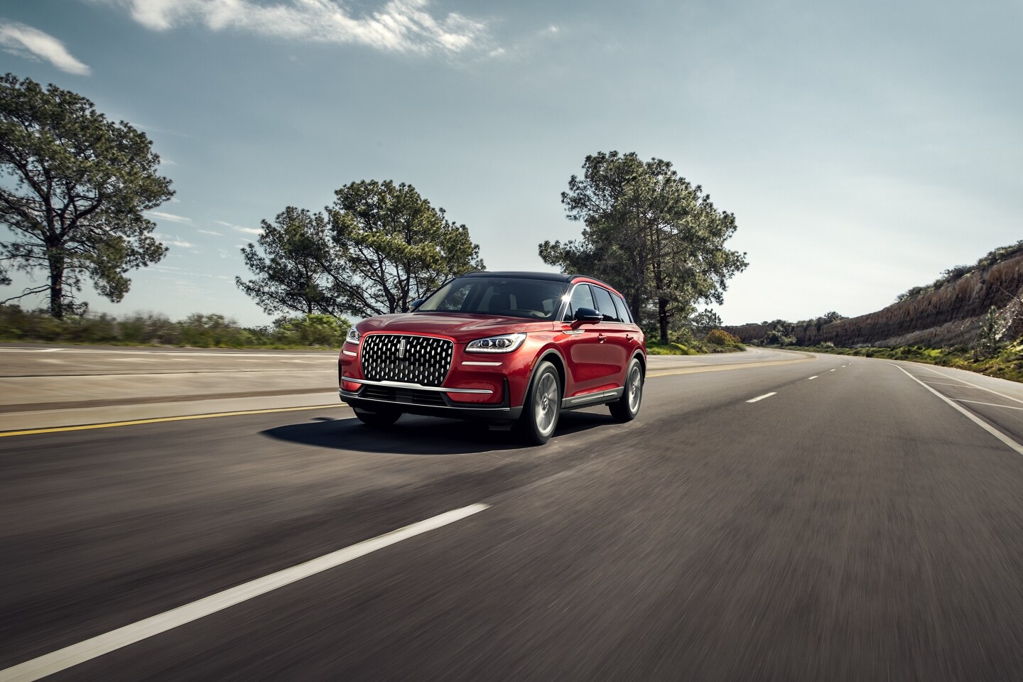 A 2026 Lincoln Corsair SUV is being driven on a country road