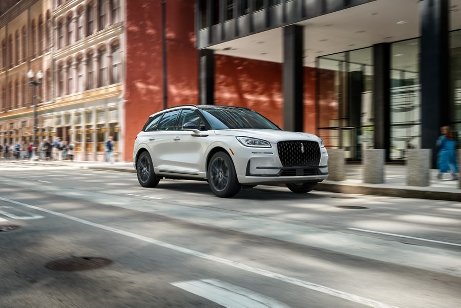 A 2026 Lincoln Corsair with the available Jet Appearance Package is being driven in a city setting