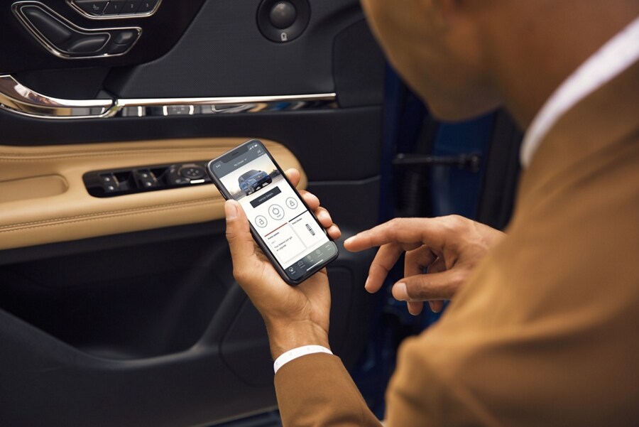 A man interacts with the Lincoln Way™ App on his smartphone