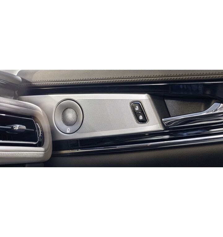A speaker cover and door controls are shown in a 2023 Lincoln Nautilus SUV