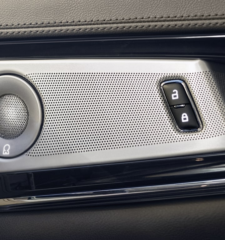 A speaker cover and door controls are shown in a 2023 Lincoln Nautilus SUV