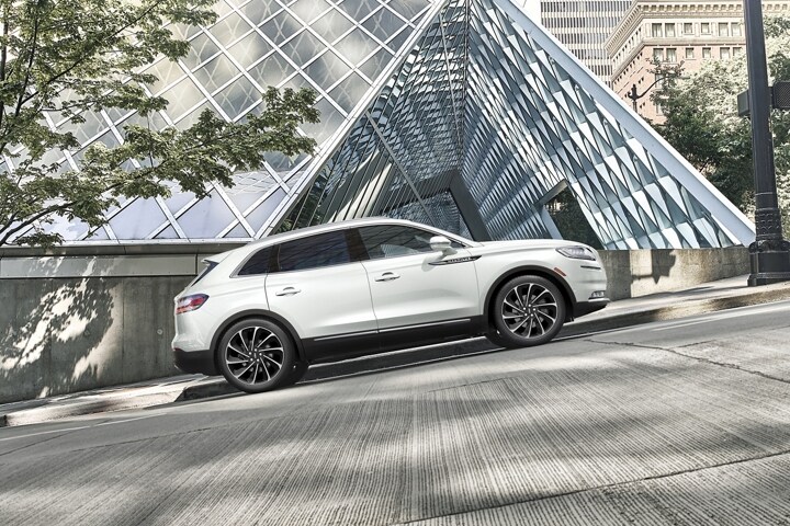 A 2023 Lincoln Nautilus SUV is shown stopped at a pedestrian crossing