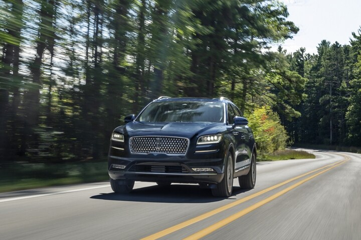 A 2023 Lincoln Nautilus Reserve SUV is being driven along a country road