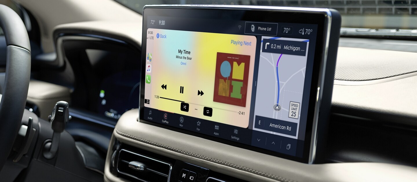 Apple CarPlay® is being used to play music on the centre touchscreen inside a 2023 Lincoln Nautilus SUV
