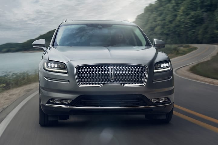 A 2023 Lincoln Nautilus SUV is shown head on to show off the dazzling headlamps