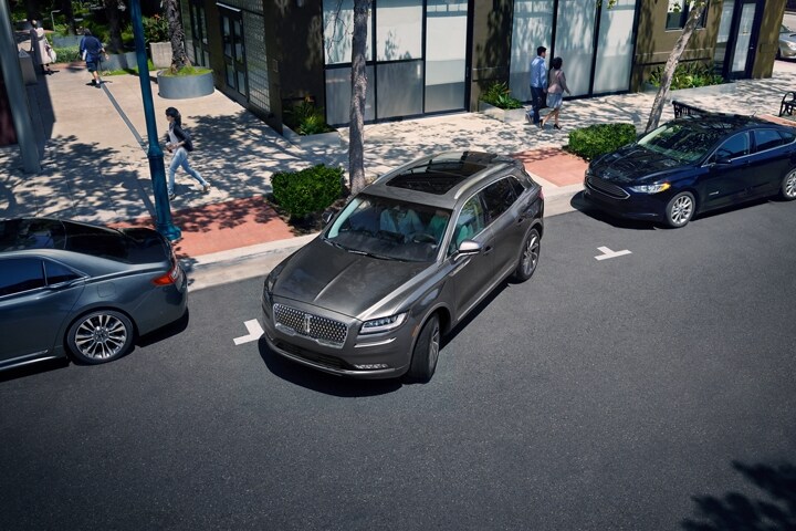 A 2023 Lincoln Nautilus SUV is shown using available enhanced active park assist