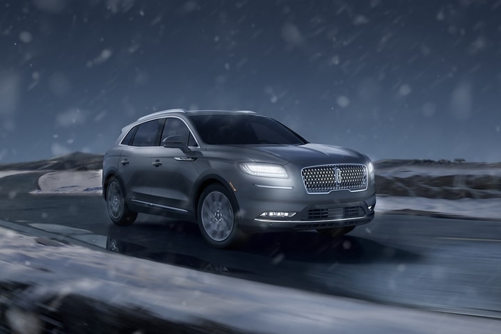 A 2023 Lincoln Nautilus SUV is driven on a snowy road
