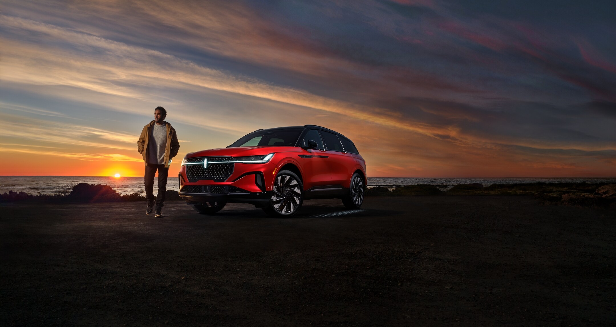 A person is leaving a 2024 Lincoln Nautilus SUV as the Lincoln Embrace lighting sequence illuminates