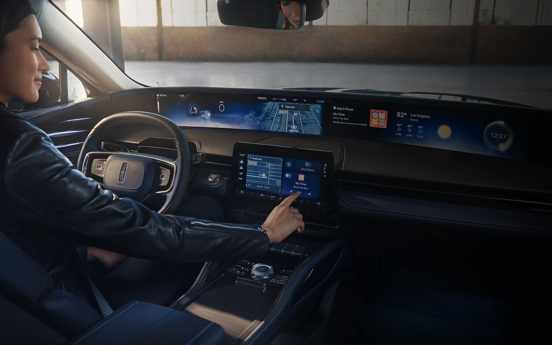 The driver of a 2025 Lincoln Nautilus SUV interacts with the centre touchscreen