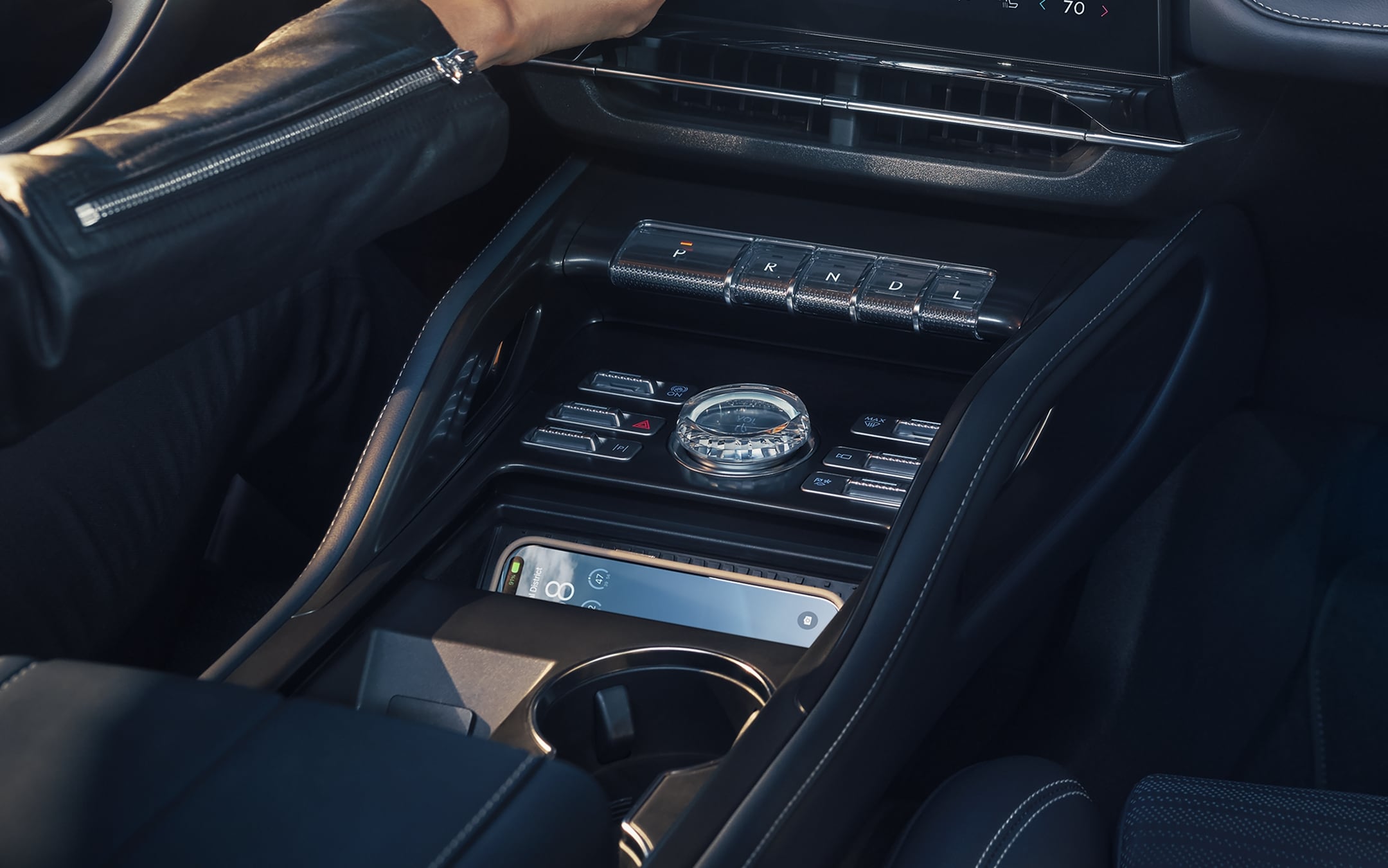 Close-up of a wireless charging pad in the center console of a 2025 Lincoln Nautilus