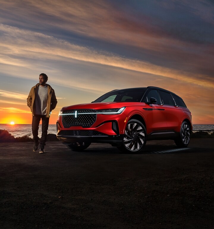 A man walks near a 2025 Lincoln Nautilus® SUV while the Lincoln Embrace welcome sequence occurs