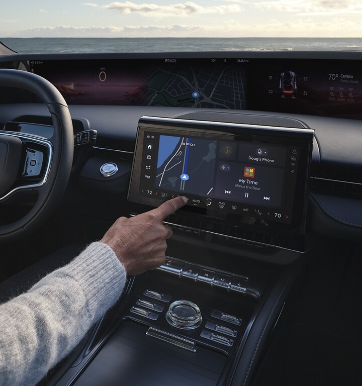 A man is shown enjoying the interior space of a 2025 Lincoln Nautilus SUV as he sits in the driver’s seat