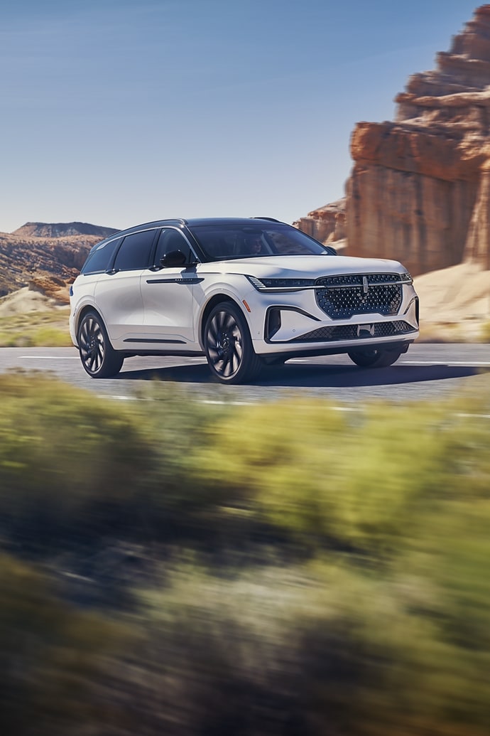 The 2025 Lincoln Nautilus driving down a road in the desert