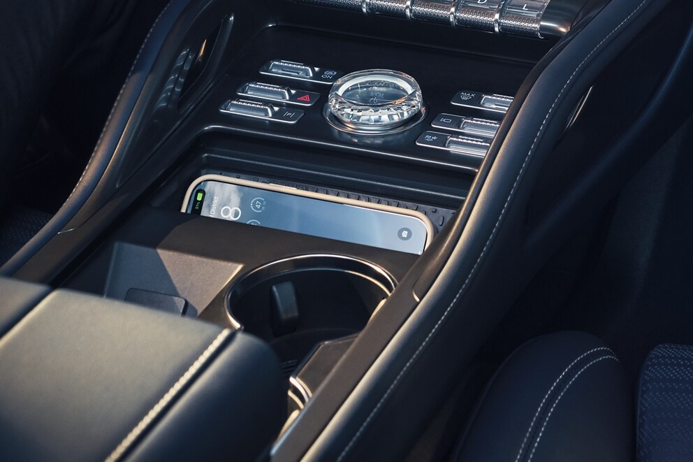 A smartphone is charging on the wireless charging pad