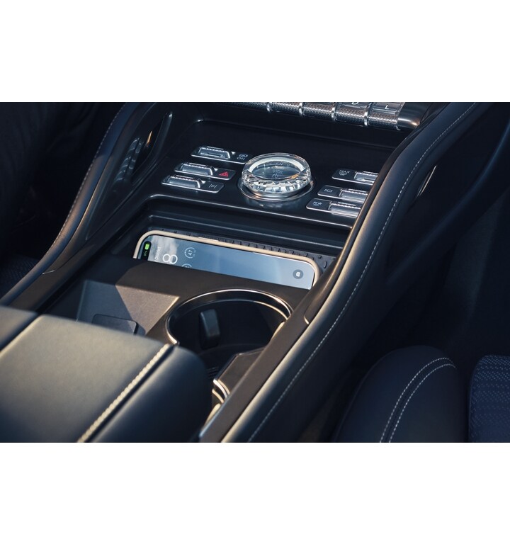 The wireless charging pad is shown charging a mobile phone in the front media bin of a 2025 Lincoln Nautilus SUV