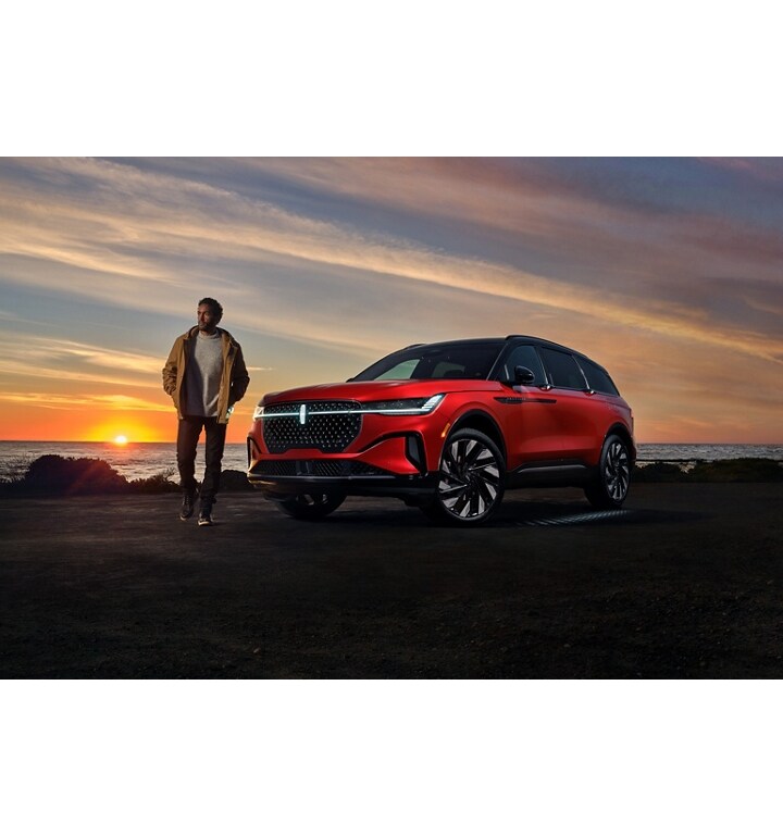 A man walks near a 2025 Lincoln Nautilus SUV while the Lincoln Embrace welcome sequence occurs