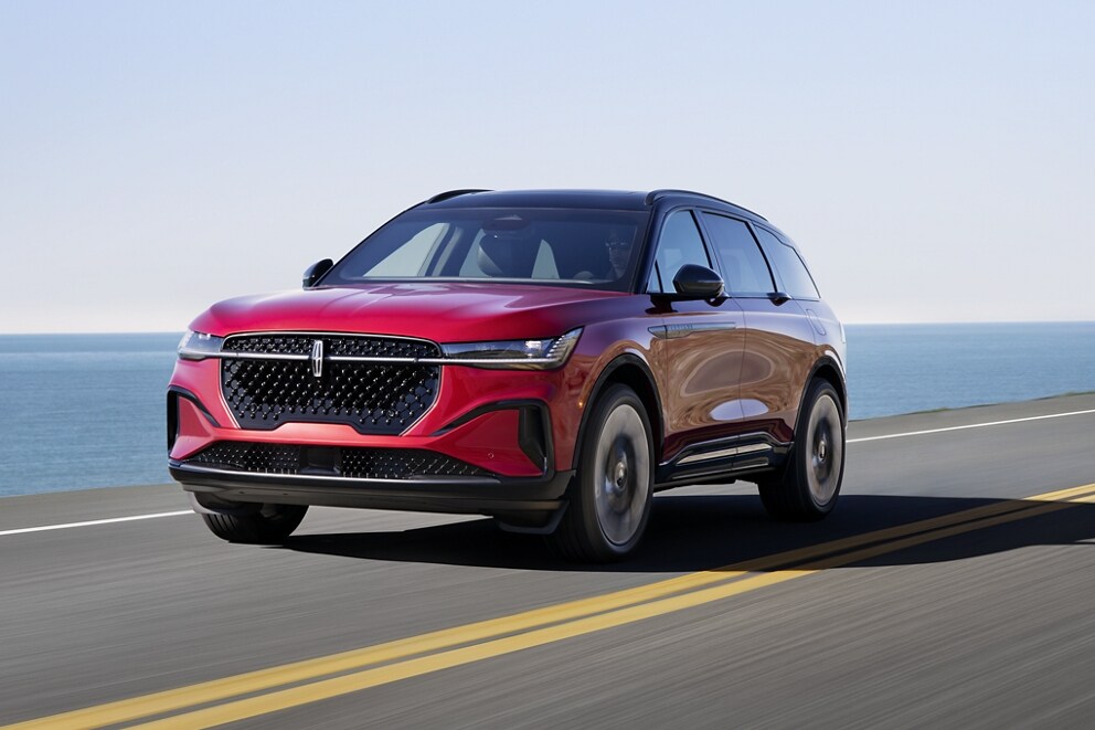 A 2025 Lincoln Nautilus SUV is being driven on a seaside roadway