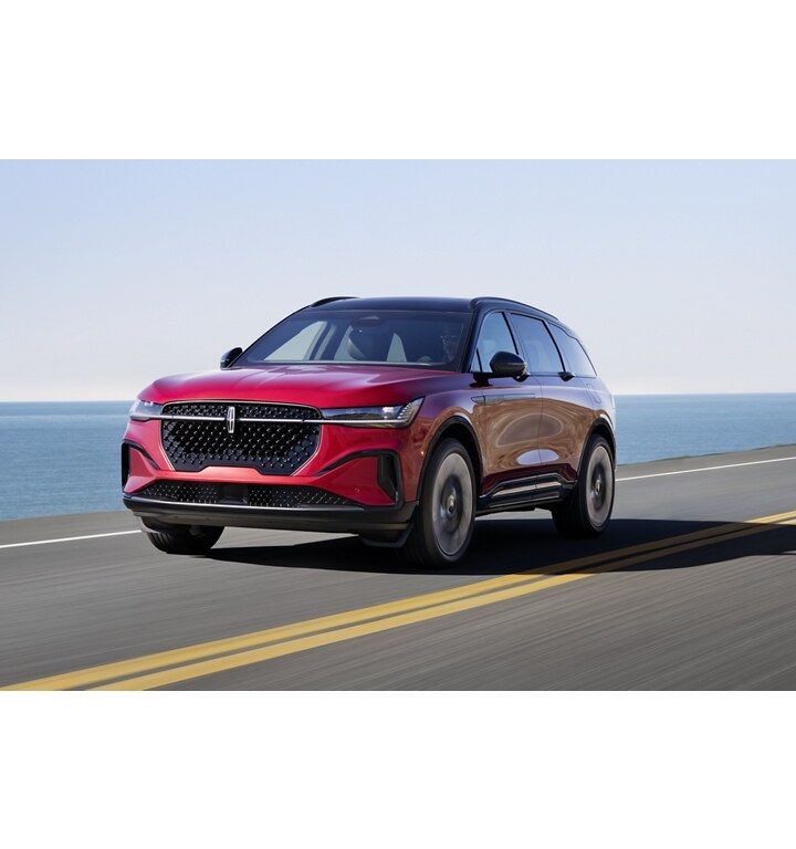 A 2025 Lincoln Nautilus SUV is being driven on a seaside roadway
