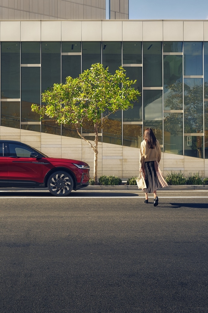 A woman is seen walking toward a 2025 Lincoln Nautilus