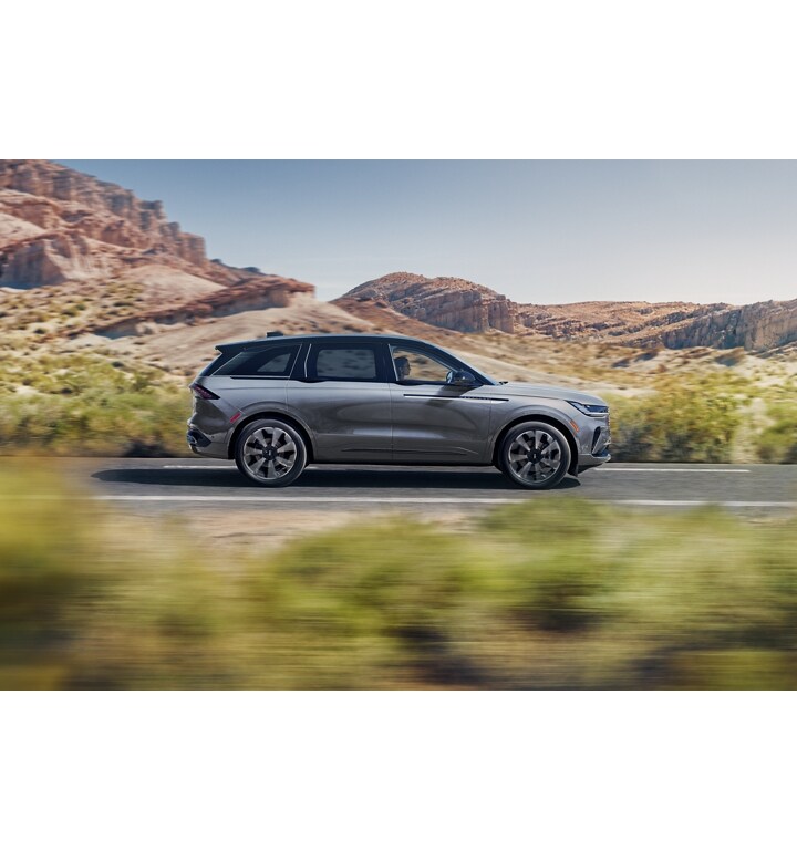 A 2025 Lincoln Nautilus Reserve SUV is being driven on a desert highway