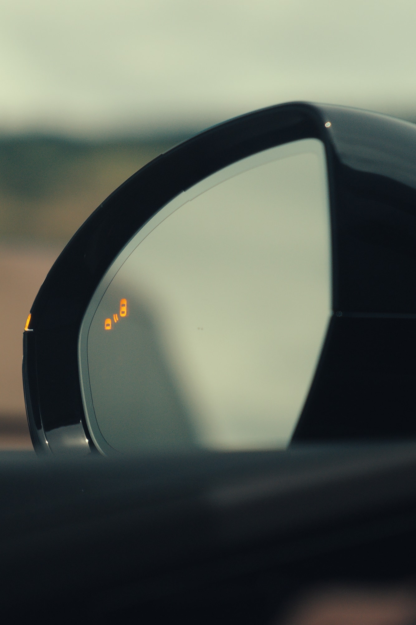 A 2026 Lincoln Nautilus SUV mirror demonstrating the Blind Spot Information System