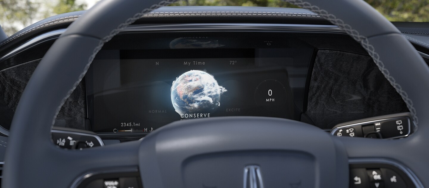 A stunning globe animation representing the Conserve drive mode illuminates the information screen behind the steering wheel with a soft blue glow
