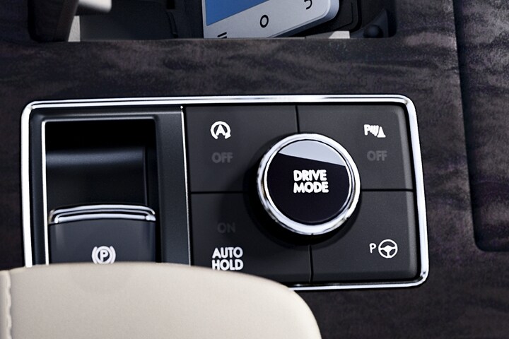 A hand is about to turn the Lincoln drive modes knob in the centre console