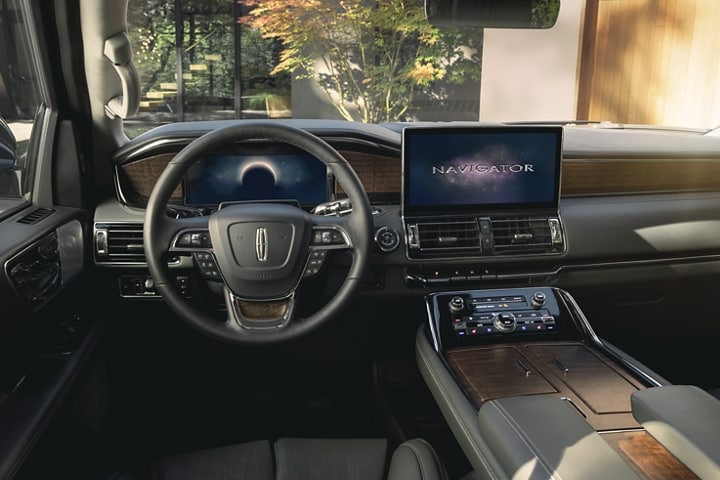 The driver’s seat and controls inside a 2023 Lincoln Navigator SUV show off the SYNC® 4 interface across the screens