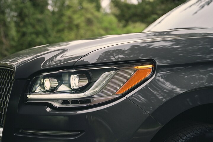 The LED headlamps on a 2023 Lincoln Reserve Navigator SUV show dynamic lines and bold form
