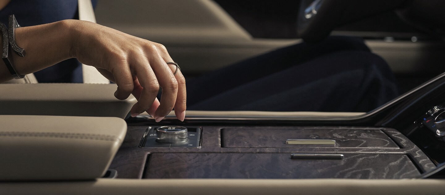 A hand is turning the Lincoln Drive Modes knob inside a 2023 Lincoln Navigator® SUV